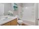 Bathroom featuring a single vanity, commode, shower-tub combo, and a decorative painting at 2201 Fairington Village Dr, Lithonia, GA 30038