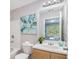 Bathroom with vanity, framed mirror, art, a commode and a tub with white tile at 2201 Fairington Village Dr, Lithonia, GA 30038