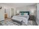 Well-lit bedroom featuring a queen-size bed, decorative rug, stylish furniture, and ample closet space at 2201 Fairington Village Dr, Lithonia, GA 30038
