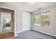 Room with light walls and grey carpet has a window and access to another room at 2201 Fairington Village Dr, Lithonia, GA 30038