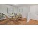 Bright dining room features modern decor, a glass table with seating for six and hardwood floors at 2201 Fairington Village Dr, Lithonia, GA 30038