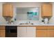 Bright kitchen featuring wood cabinets, granite countertops, stainless steel sink, and modern appliances at 2201 Fairington Village Dr, Lithonia, GA 30038