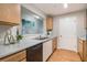 Well-lit kitchen featuring wood cabinets, granite countertops, stainless steel sink, and modern appliances at 2201 Fairington Village Dr, Lithonia, GA 30038