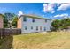A well maintained backyard featuring a lush lawn, wooden fence, and a charming two-story home exterior at 3772 Sunbridge Dr, Snellville, GA 30039