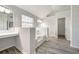 Bright bathroom featuring a soaking tub, vanity area, and closet access at 3772 Sunbridge Dr, Snellville, GA 30039