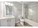 Well-lit bathroom with vanity, toilet, tub, and sliding glass door at 3772 Sunbridge Dr, Snellville, GA 30039