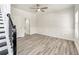 Light-filled bedroom featuring gray wood-look floors, white wainscoting, and a ceiling fan at 3772 Sunbridge Dr, Snellville, GA 30039