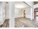 Elegant dining room with gray wood-look floors, wainscoting, a modern chandelier, and built-in cabinets at 3772 Sunbridge Dr, Snellville, GA 30039