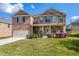 Charming brick two-story home featuring a two-car garage, manicured lawn, and covered front porch at 3772 Sunbridge Dr, Snellville, GA 30039