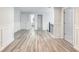 Upstairs hallway featuring modern plank flooring, trimwork and neutral walls at 3772 Sunbridge Dr, Snellville, GA 30039