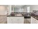 The kitchen features stainless steel appliances, granite counters, and a breakfast bar at 3772 Sunbridge Dr, Snellville, GA 30039