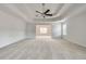 Spacious main bedroom with tray ceiling and neutral walls and carpets at 3772 Sunbridge Dr, Snellville, GA 30039