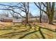 Full backyard with mature trees shading grass and structures at 461 Deckner Sw Ave, Atlanta, GA 30310