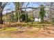Large, grassy backyard features mature trees and outbuilding at 461 Deckner Sw Ave, Atlanta, GA 30310