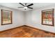 Bedroom featuring hardwood floors, neutral walls, windows with wood trim, and overhead fan at 461 Deckner Sw Ave, Atlanta, GA 30310