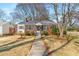 Charming brick home with manicured landscaping, front yard, walkway, and mature trees under a bright blue sky at 461 Deckner Sw Ave, Atlanta, GA 30310