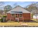 Charming brick home featuring a fenced front yard, a small porch and mature landscaping at 461 Deckner Sw Ave, Atlanta, GA 30310