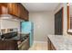 Kitchen featuring new appliances, granite countertops, wood cabinets, and a retro blue refrigerator at 461 Deckner Sw Ave, Atlanta, GA 30310