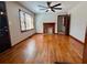 Bright living room features hardwood floors, a brick fireplace, and a large window overlooking the front yard at 461 Deckner Sw Ave, Atlanta, GA 30310