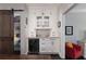 Elegant bar area with custom cabinetry, a wine cooler, and sliding barn door to a pantry at 808 Dixie Ne Ave, Atlanta, GA 30307