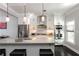 Spacious white kitchen with a large island, stainless steel appliances, and modern pendant lighting at 808 Dixie Ne Ave, Atlanta, GA 30307