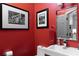 Stylish powder room with bold red walls, modern fixtures, and decorative artwork for added elegance at 808 Dixie Ne Ave, Atlanta, GA 30307