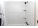 Stylish shower featuring white subway tile, black fixtures, and convenient corner shelves at 808 Dixie Ne Ave, Atlanta, GA 30307