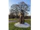 A stone sculpture is standing in a green space with trees in the background at 808 Dixie Ne Ave, Atlanta, GA 30307