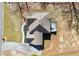 An aerial view of the home's roof, deck, and landscaping surrounded by mature trees at 1880 Oak Wind Ln, Buford, GA 30519