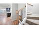 Carpeted staircase with wood and iron railing, adjacent to a kitchen with dark cabinets at 4116 Mars Bay # 27, Acworth, GA 30101