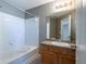 Bathroom features a shower-tub combo, modern vanity, and neutral color scheme at 7432 Battlecreek Ln, Jonesboro, GA 30236