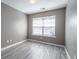Bedroom featuring a window that provides natural light and stylish gray laminate flooring at 7432 Battlecreek Ln, Jonesboro, GA 30236