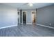 Bedroom with gray walls and flooring, showing walk in closet and bathroom at 7432 Battlecreek Ln, Jonesboro, GA 30236
