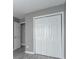 Bedroom closet with bi-fold doors and gray laminate flooring at 7432 Battlecreek Ln, Jonesboro, GA 30236