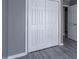Bedroom closet with bi-fold doors and gray laminate flooring at 7432 Battlecreek Ln, Jonesboro, GA 30236