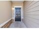 Stylish front door featuring a stone facade and a modern lighting fixture at 7432 Battlecreek Ln, Jonesboro, GA 30236