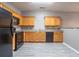 Well-equipped kitchen with plentiful cabinetry, black appliances, and modern flooring at 7432 Battlecreek Ln, Jonesboro, GA 30236