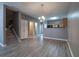 Open concept living room with gray walls, modern floors, and elegant chandelier at 7432 Battlecreek Ln, Jonesboro, GA 30236