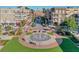 An aerial view shows a beautiful water fountain surrounded by manicured gardens in a bustling community with shops and restaurants at 245 Dennis Dr, Alpharetta, GA 30009