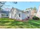 Spacious, grassy backyard featuring a view of the home's exterior at 245 Dennis Dr, Alpharetta, GA 30009