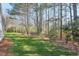 Lush backyard with mature trees offering privacy and shade at 245 Dennis Dr, Alpharetta, GA 30009