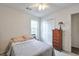 Simple bedroom with a queen bed, a wooden dresser, and a closet at 245 Dennis Dr, Alpharetta, GA 30009