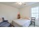 Cozy bedroom with a full size bed, soft chair, and natural light from the window at 245 Dennis Dr, Alpharetta, GA 30009