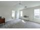 Spacious bedroom with neutral carpet, ceiling fan, and natural light from windows at 245 Dennis Dr, Alpharetta, GA 30009