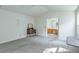 Bright bedroom featuring soft carpet, a ceiling fan, natural light, and connected bathroom at 245 Dennis Dr, Alpharetta, GA 30009