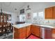 Bright kitchen open to dining area, with a stainless steel dishwasher, and wood cabinets at 245 Dennis Dr, Alpharetta, GA 30009