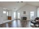 Cozy living room featuring vaulted ceiling, fireplace and hardwood floors at 245 Dennis Dr, Alpharetta, GA 30009