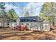 Backyard with deck and mature trees on a sunny day at 50 Riverside Ct, Hampton, GA 30228