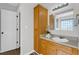 Bright bathroom with wood cabinets, modern sink and medicine cabinet at 50 Riverside Ct, Hampton, GA 30228