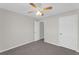 Neutral bedroom featuring a ceiling fan, two entryways and closet at 50 Riverside Ct, Hampton, GA 30228